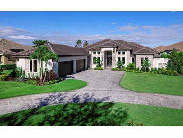 Luxury home with three-car garage, paver driveway, and lush landscaping at 19405 Ganton Ave, Lakewood Ranch, FL 34202