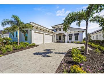 Beautiful single-Gathering home with a paved driveway, well-manicured landscaping, and a two-car garage at 8328 Sea Glass Ct, Sarasota, FL 34240