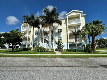 Three-story condo building with palm trees and ample parking at 3404 79Th Street W Cir # 203, Bradenton, FL 34209