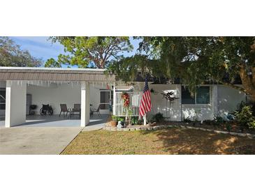 Inviting exterior with carport and landscaped yard at 3935 Panola Ln # 183, Sarasota, FL 34232