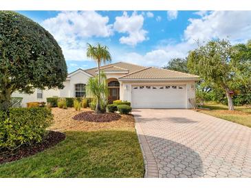 Single-story home with landscaped yard, driveway, and two-car garage at 6504 Copper Ridge Trl, Bradenton, FL 34201