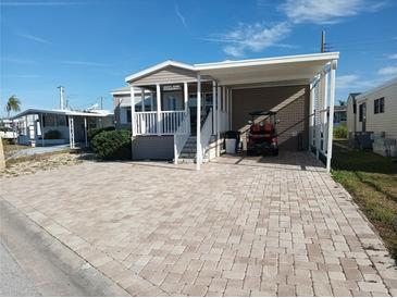 Mobile home with carport and paved driveway at 1564 Blind Brook Dr, Sarasota, FL 34234