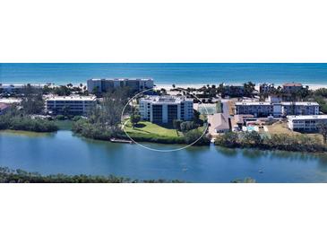 Aerial view of waterfront condo building with tennis courts and pool at 3240 Gulf Of Mexico Dr # B504, Longboat Key, FL 34228
