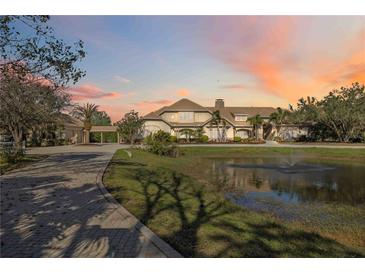 Grand estate with circular drive, pond, and manicured landscaping at 6200 Saddle Oak Trl, Sarasota, FL 34241