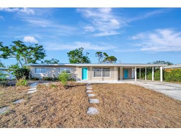 Ranch style home with carport and turquoise door at 2705 Sunnyside St, Sarasota, FL 34239