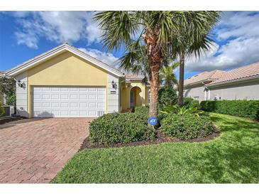 Single-story house with a two-car garage and well-manicured lawn at 5759 Benevento Dr, Sarasota, FL 34238