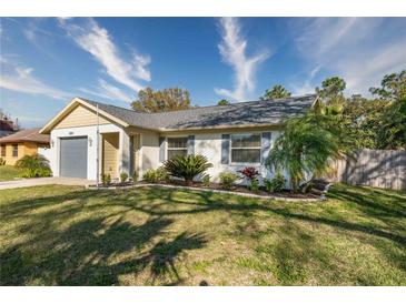 Charming single-story home with landscaped lawn and gray garage door at 4532 N Shade Ave, Sarasota, FL 34234