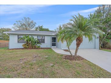 Charming one-story home featuring a well-manicured lawn and inviting curb appeal at 2551 W Burr Oak Ct, Sarasota, FL 34232