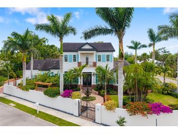 Stunning two-story home with lush landscaping, privacy wall, and a charming fountain entrance at 1810 Lincoln Dr, Sarasota, FL 34236