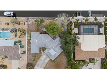 Aerial view of a charming single-Gathering home with a dock, pool, and lush landscaping at 5402 Shadow Lawn Dr, Sarasota, FL 34242
