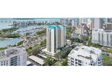 Stunning aerial view of a luxury high-rise condo building with views of the bay and the cityscape at 340 S Palm Ave # Pl1, Sarasota, FL 34236