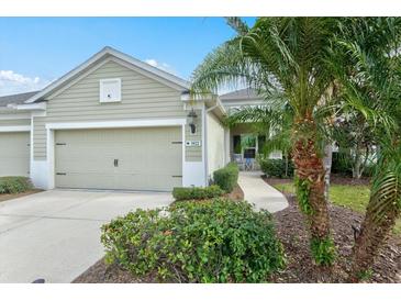 Charming single-story home with a well-manicured lawn, attached garage, and tasteful landscaping at 3922 Wildgrass Pl, Parrish, FL 34219