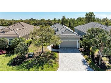 Charming home with a two-car garage, paver driveway, and well-maintained landscaping at 5023 Tobermory Way, Bradenton, FL 34211