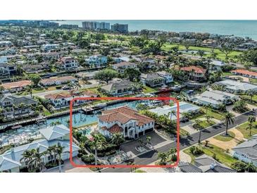 Stunning waterfront home with private boat dock, lush landscaping, and easy access to the bay at 550 Yardarm Ln, Longboat Key, FL 34228