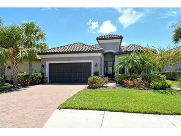 Charming single-Gathering home featuring a tile roof, well-maintained landscaping, and an attached two-car garage at 4020 Cascina Way, Sarasota, FL 34238