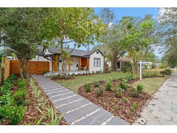 Charming white craftsman home featuring professional landscaping, quaint front porch, and inviting walkway at 4536 1St N Ave, St Petersburg, FL 33713