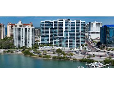 Modern high-rise condo building featuring sleek architectural lines, glass balconies, and stunning waterfront views at 1155 N Gulfstream Ave # 607, Sarasota, FL 34236