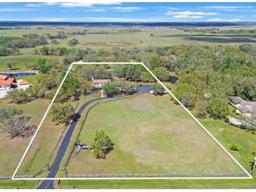 Wide aerial view of the extensive property, with a long driveway and abundant trees at 12001 Backwater Rd, Sarasota, FL 34240