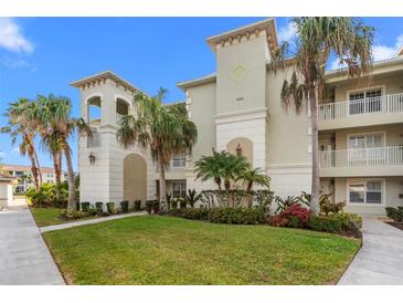 Inviting condominium complex featuring lush landscaping and charming architectural details on a sunny day at 1000 San Lino Cir # 1032, Venice, FL 34292