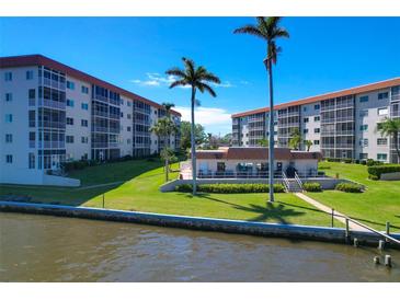 Beautiful waterfront condo community with lush landscaping and a view of the water at 1600 1St W Ave # 304A, Bradenton, FL 34205