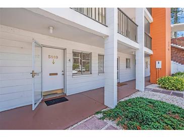 Condo entrance featuring a white door, white siding, and a small outdoor area at 5889 Canal Dr # I4, Bradenton, FL 34207