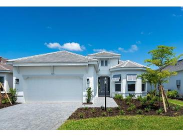 Charming single-story home with a two-car garage, well manicured landscaping, and a neatly paved walkway at 8024 Moonbeam Ave, Sarasota, FL 34241