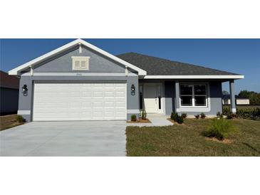 Charming single-story home featuring a two-car garage, and well-maintained landscaping at 2640 Averland Loop, North Port, FL 34287