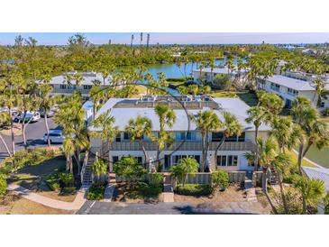 Beautiful waterfront property featuring lush landscaping and serene water views at 6750 Gulf Of Mexico Dr # 153, Longboat Key, FL 34228
