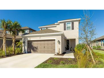 Charming two-story home featuring a two car garage and well-manicured landscaping at 8612 Evening Dr, Sarasota, FL 34241