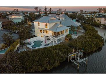 Stunning coastal home with a private pool, dock, and picturesque water views at 114 Gull Dr, Anna Maria, FL 34216