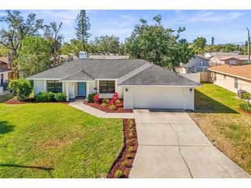 Charming ranch-style home featuring a well-manicured lawn and a blue front door at 7507 3Rd Nw Ave, Bradenton, FL 34209