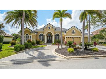 Stunning home featuring a manicured front yard, beautiful landscaping and a circular driveway at 13616 Legends Walk Ter, Lakewood Ranch, FL 34202