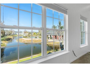 Bright window with a view of the community pond and pool at 5711 Soldier Cir # 204, Sarasota, FL 34233