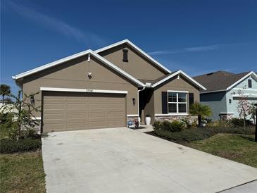 Charming single-Gathering home with a two-car garage, well-maintained landscaping, and a neutral color palette at 17741 Canopy Pl, Bradenton, FL 34211