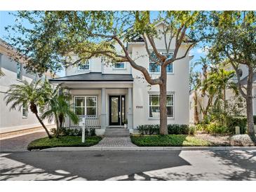 Charming two-story home featuring manicured landscaping, a welcoming porch, and a well-maintained front yard at 1746 Stapleton St, Sarasota, FL 34239