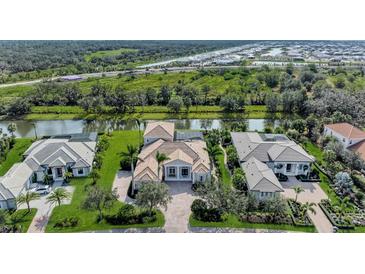 Stunning aerial view of luxurious homes along a scenic canal in a well-maintained community at 3360 Founders Club Dr, Sarasota, FL 34240