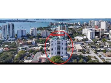 Aerial view of a high-rise condo building on the water, offering a glimpse of prime real estate and waterfront lifestyle at 505 S Orange Ave # 501, Sarasota, FL 34236