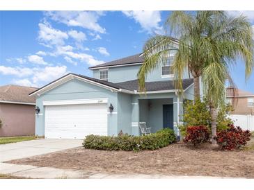Charming two-story home featuring a two-car garage and a welcoming front porch with a lovely landscaped yard at 2347 Richwood Pike Dr, Ruskin, FL 33570