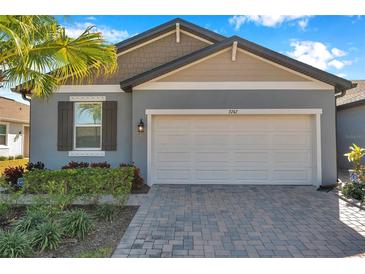 Charming single Gathering home featuring a two-car garage and beautifully landscaped front yard at 3747 Laughing Dove Ave, Sun City Center, FL 33573