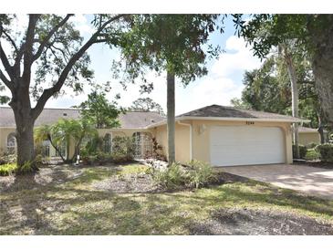 Charming single-story home featuring a two-car garage and tropical landscaping at 5244 Marsh Field Rd # 6, Sarasota, FL 34235
