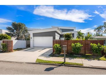 Contemporary home featuring a two-car garage, unique landscaping, and a modern gray and white color scheme at 2254 Hawthorne St, Sarasota, FL 34239