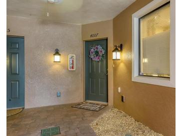 Inviting condo entrance with a decorative wreath on the dark green door and ambient lighting at 4007 Overture Cir, Bradenton, FL 34209