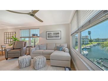 Bright living room with a comfortable couch and a scenic view of the waterfront at 4320 Falmouth Dr # 301, Longboat Key, FL 34228