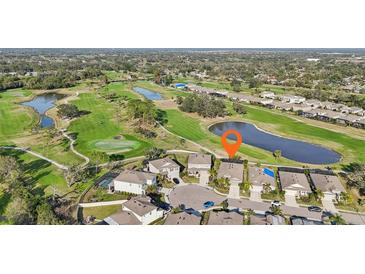 Aerial view of a two-story home located on a cul-de-sac overlooking a golf course and pond at 7812 Birdie Bend Way, Sarasota, FL 34241