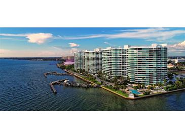 Stunning aerial view of waterfront condos with private boat docks and a refreshing pool at 888 Blvd Of The Arts # 1608, Sarasota, FL 34236
