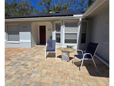 Charming home featuring a brick paved courtyard with seating to enjoy the outdoors at 4553 Linwood St, Sarasota, FL 34232