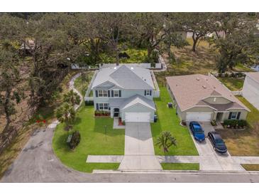 Aerial shot of a two-story home with a well-manicured lawn and mature landscaping, showcasing its desirable curb appeal at 5809 71St E St, Palmetto, FL 34221