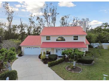 Charming two-story home with a red roof, lush lawn, and mature landscaping at 9142 16Th Avenue Nw Cir, Bradenton, FL 34209