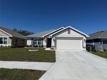 Charming single-Gathering home with a manicured lawn and a two-car garage, perfect for suburban living at 2556 Averland Loop, North Port, FL 34287