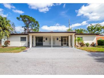 Charming single-story duplex with a spacious driveway and well-maintained landscaping at 6205 Green View Dr # 129, Sarasota, FL 34231